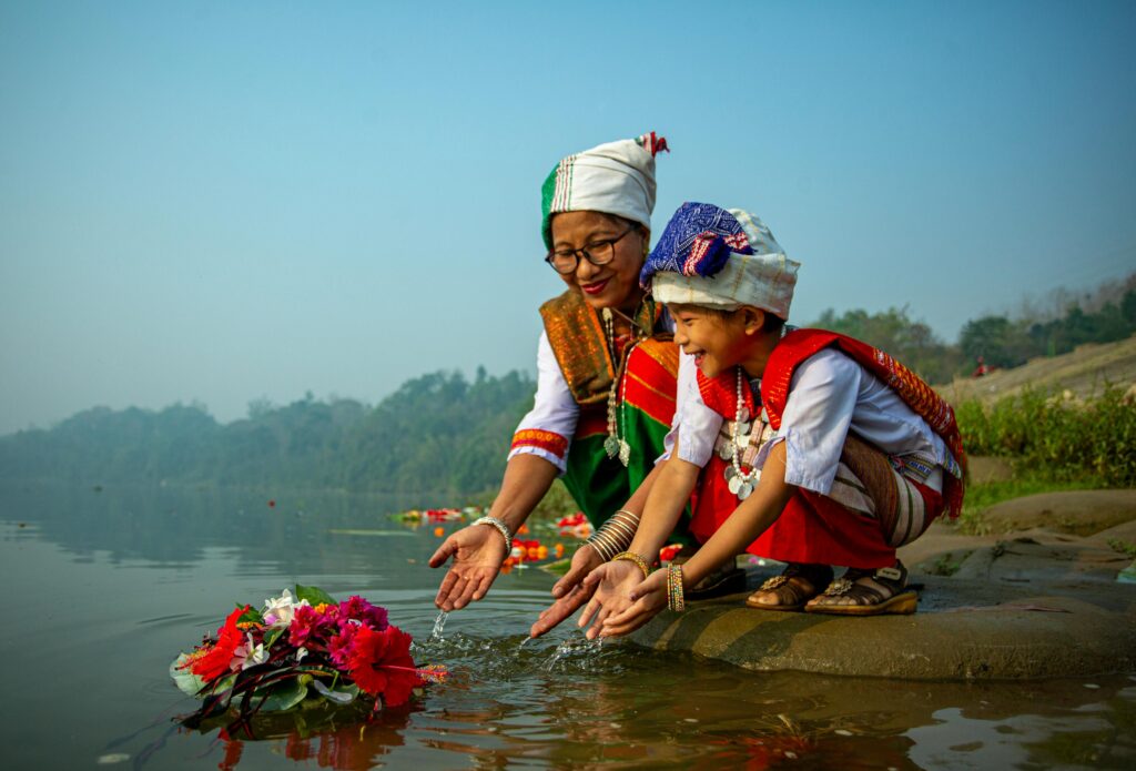 A joyous moment of a mother and child celebrating Boishakh on a riverbank in Bangladesh.